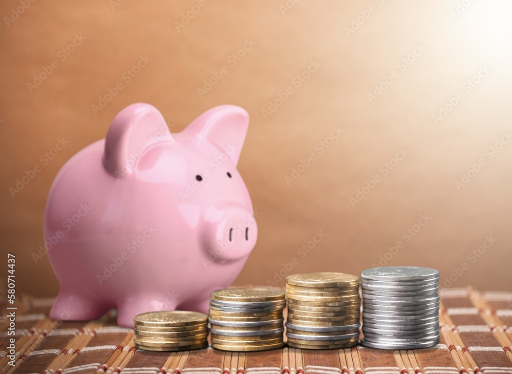 Poster A piggy bank with stacks of coins on the desk