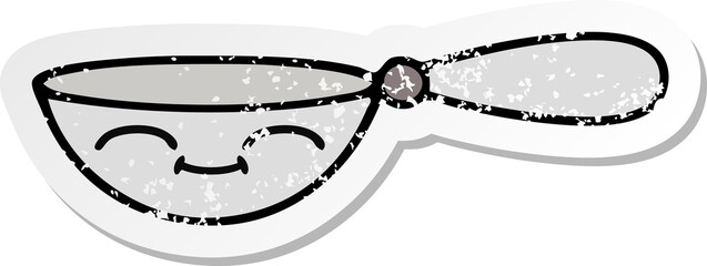 distressed sticker of a cute cartoon measuring spoon