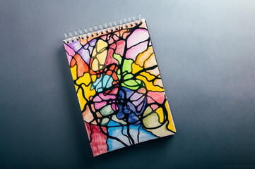 Colorful neurographic drawing on paper with color pencils and markers. Psychological therapy drawings for releasing stress and problem solving