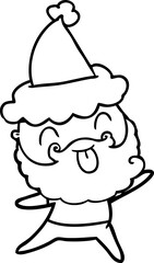 man with beard sticking out tongue wearing santa hat