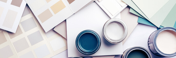 Tiny sample paint cans during house renovation, process of choosing paint for the walls, different...