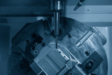 The 5-axis CNC milling machine cutting the automotive parts with ball end mill tool.