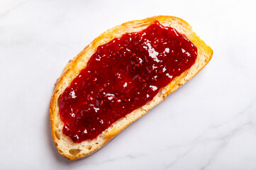 Open Sandwich with toasted sourdough white bread slices and raspberry jam