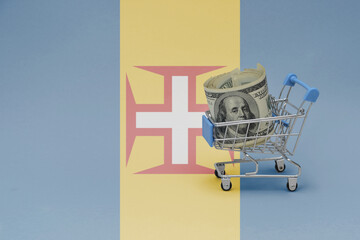 Metal shopping basket with dollar money banknote on the national flag of madeira background. consumer basket concept. 3d illustration
