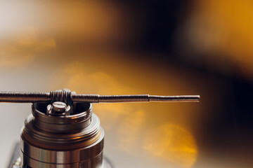 Specialist replaces spring for smoking vape.Professional maintaining electronic cigarette in...