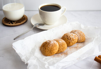 
Photo of oatmeal cookies, cookies, cinnamon, black coffee. on a white table