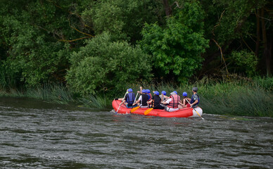 A group of people on the stormy river New Bug. Rafting Ukraine.