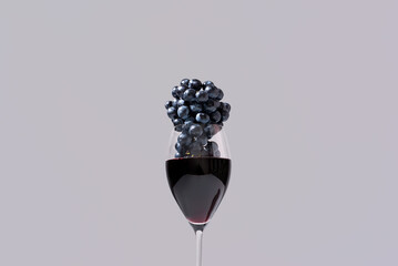 Racimo de uvas negras dentro de una copa de vino tinto