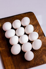 Easter eggs. Chicken eggs on a wooden board. Eggs on a white background