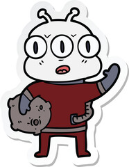 sticker of a cartoon three eyed alien waving