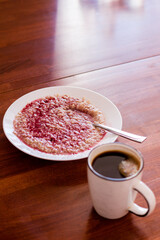 Breakfast on the table. A cup of coffee on the table. A cup of coffee and a plate of oatmeal.