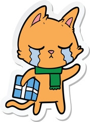 sticker of a crying cartoon cat holding christmas present