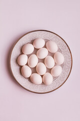 Chicken eggs on a plate. We are preparing for Easter. Beautiful tableware. Eggs on a white background