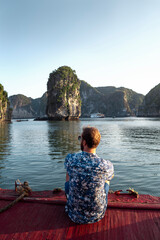 A beautiful young man travels to Southeast Asia to enjoy stunning views of Halong Bay in Vietnam