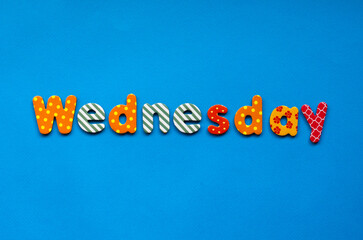 colored word Wednesday  on  blue paper background