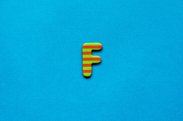 letter f on blue paper background
