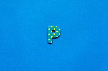 letter p on blue paper background