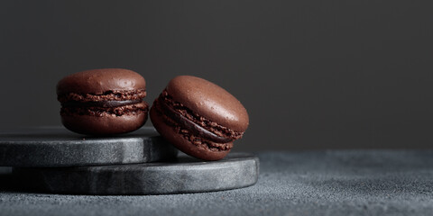 Chocolate eco handmade natural macaroons on dark background in the darkmood style