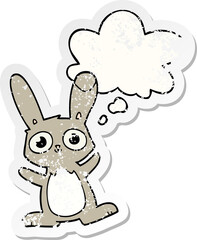 cute cartoon rabbit and thought bubble as a distressed worn sticker