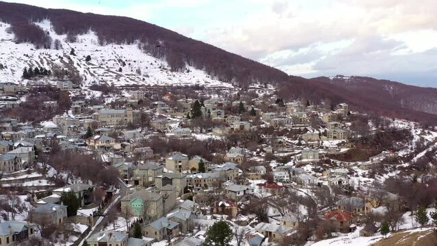 Aerial Drone Video Footage above snowy houses in Nymfaio , Makedonia , Greece