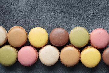 Colorful pastel eco handmade natural macaroons on dark background. Gift for 8 March, International Women's Day, Valentine Day, top view