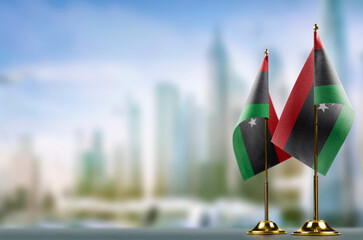 Small flags of the Libya on an abstract blurry background