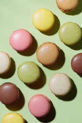 Colorful pastel eco handmade macaroons on green background with a shadow. Gift for 8 March, International Women's Day, Valentine Day