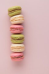 Macaroons on pink background, colorful french cookies pattern. Gift for 8 March, International Women's Day, Valentine Day