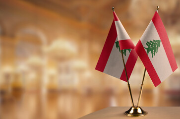 Small flags of the Lebanon on an abstract blurry background