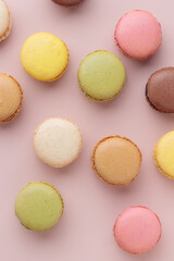 Macaroons on pink background, colorful french cookies pattern. Gift for 8 March, International Women's Day, Valentine Day