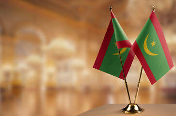 Small flags of the Mauritania on an abstract blurry background