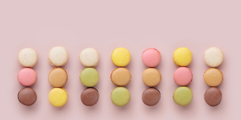 Macaroons on pink background, colorful french cookies pattern. Gift for 8 March, International Women's Day, Valentine Day