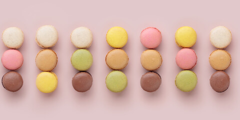 Macaroon pattern on pink background, colorful french cookies pattern. Gift for 8 March, International Women's Day, Valentine Day