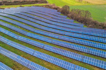 An open space solar system between fields and meadows in Germany from a drone perspective