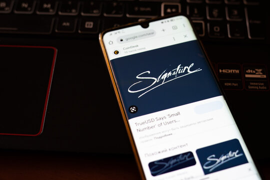 Tarragona, Spain - March 13, 2023: Signature Bank logo with stock market chart background.