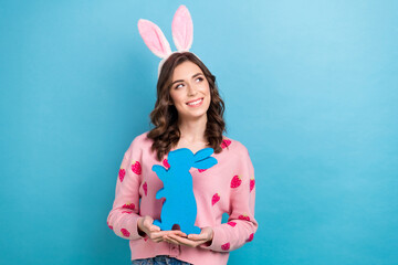 Photo of shiny dreamy woman wear pink cardigan hare hairband holding bunny emtpy space isolated...