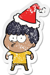 distressed sticker cartoon of a curious boy wearing santa hat