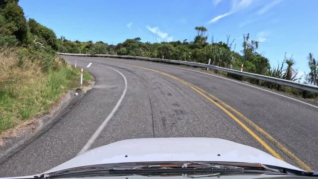 Driving hyperlapse - cliffside highway along coast in New Zealand
