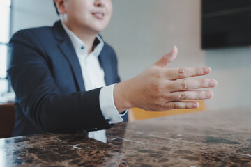 Close up of young business man and digital number of stock market background to represent...