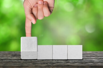 Set of wooden cube blocks with human hand