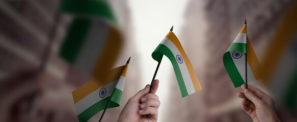 A group of people holding small flags of the India in their hands