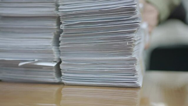 Close-up, Stack of document on the table. Hand of man put document in the office.