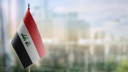 Small flags of the Iraq on an abstract blurry background