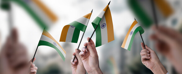 A group of people holding small flags of the India in their hands