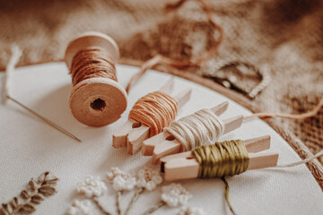 Threads, wooden, hoop on the background of old fabric burlap © Evgenia