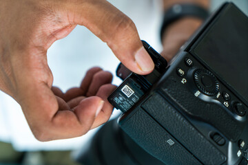 Removing Camera battery from mirrorless camera, heck your Battery day concept image