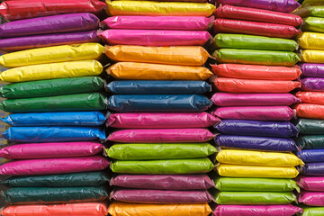 12 March 2023, Pune, India, Dry colours packed in plastic pack placed at market shop for sale for Indian Festival Holi. Holi is traditional Indian festival of colours.