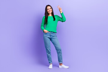 Full body photo of gorgeous lady model showing presenting v sign gesture say hi friends good mood isolated purple color background