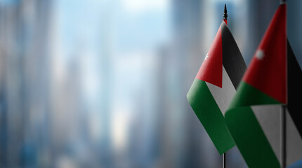 Small flags of the Jordan on an abstract blurry background