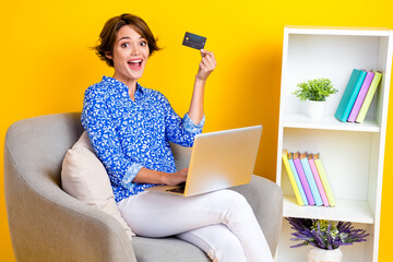 Full length photo of cute funny woman dressed blue blouse online shopping modern gadget isolated yellow color background